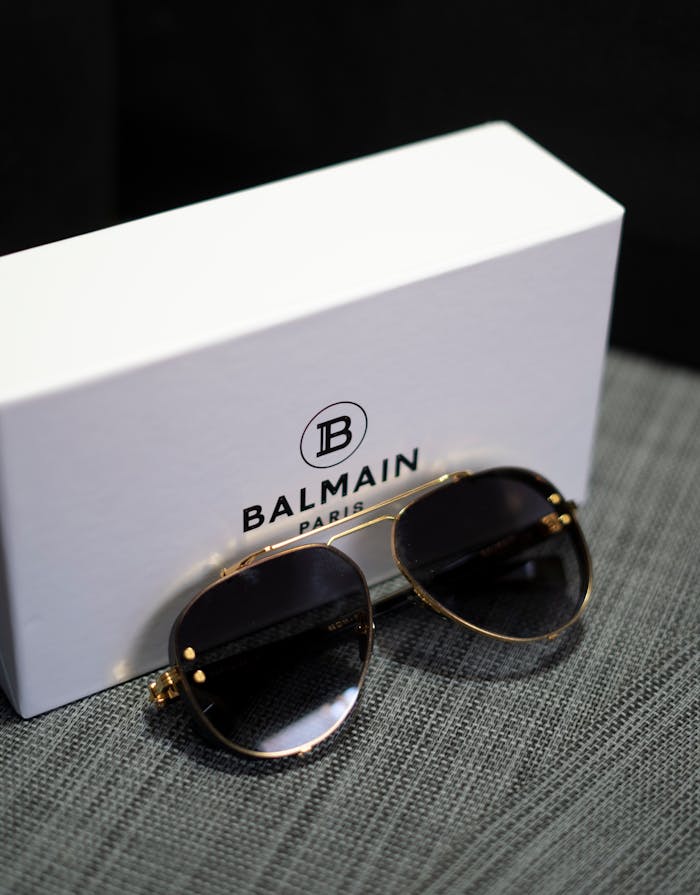 Elegant Balmain sunglasses alongside branded box on a stylish surface.