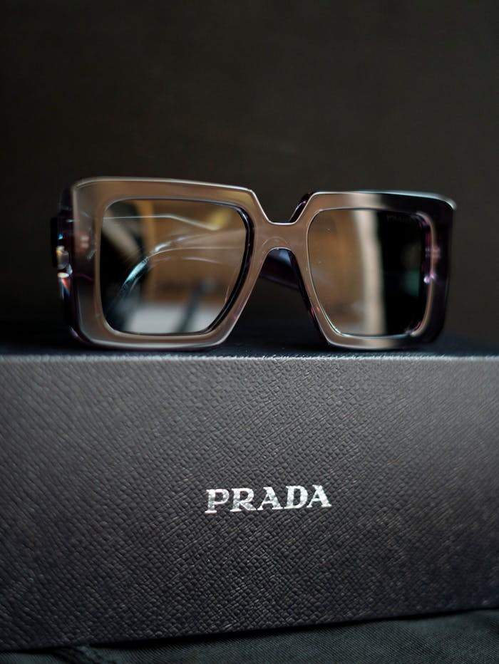 Elegant Prada sunglasses showcased on a branded box, ideal for fashion lovers.